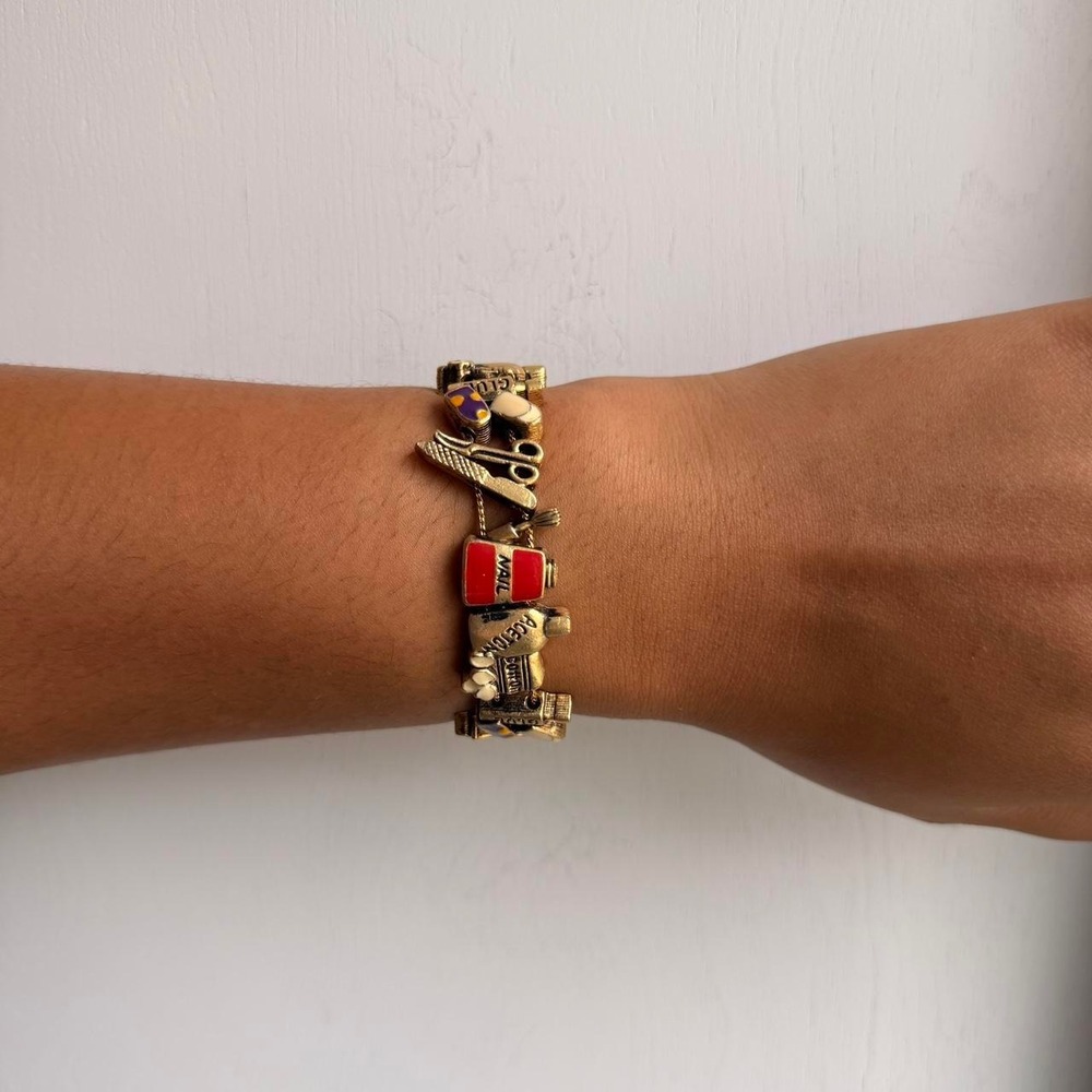 GOLD TONE NAIL SALON THEMED SLIDING CHARM BRACELET